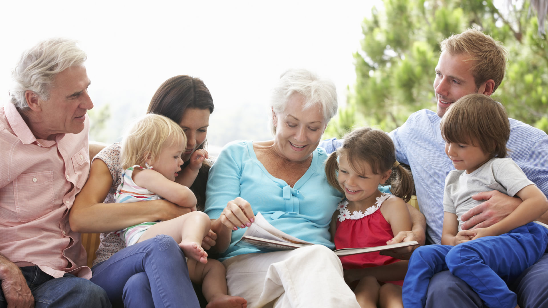 Multigenerational Family sitting on a couch reading